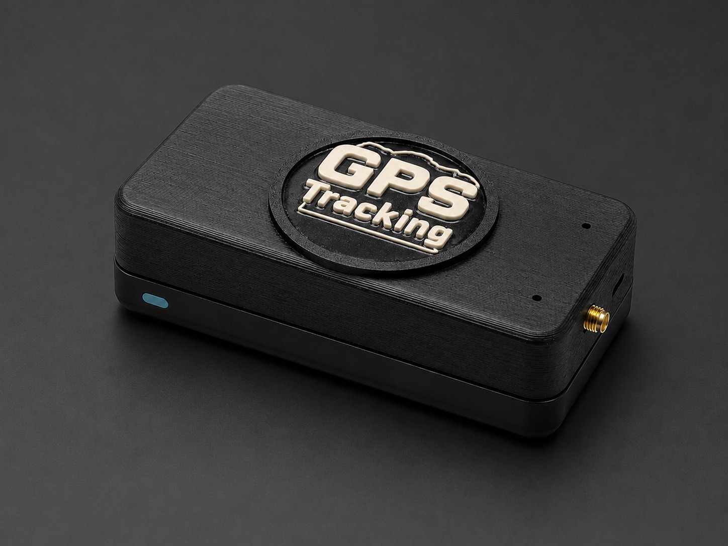 The GPS Tracking Version 01 unit: a black enclosure with a raised GPS Tracking emblem